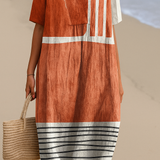 Eva – Elegantan midi haljina u terracotta boji s grafičkim prugama